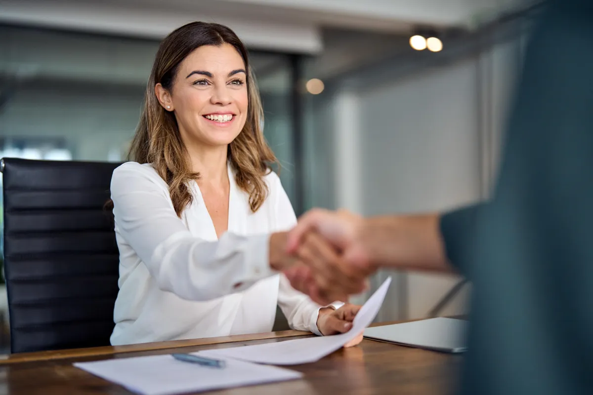 Woman shaking hands in a business meeting