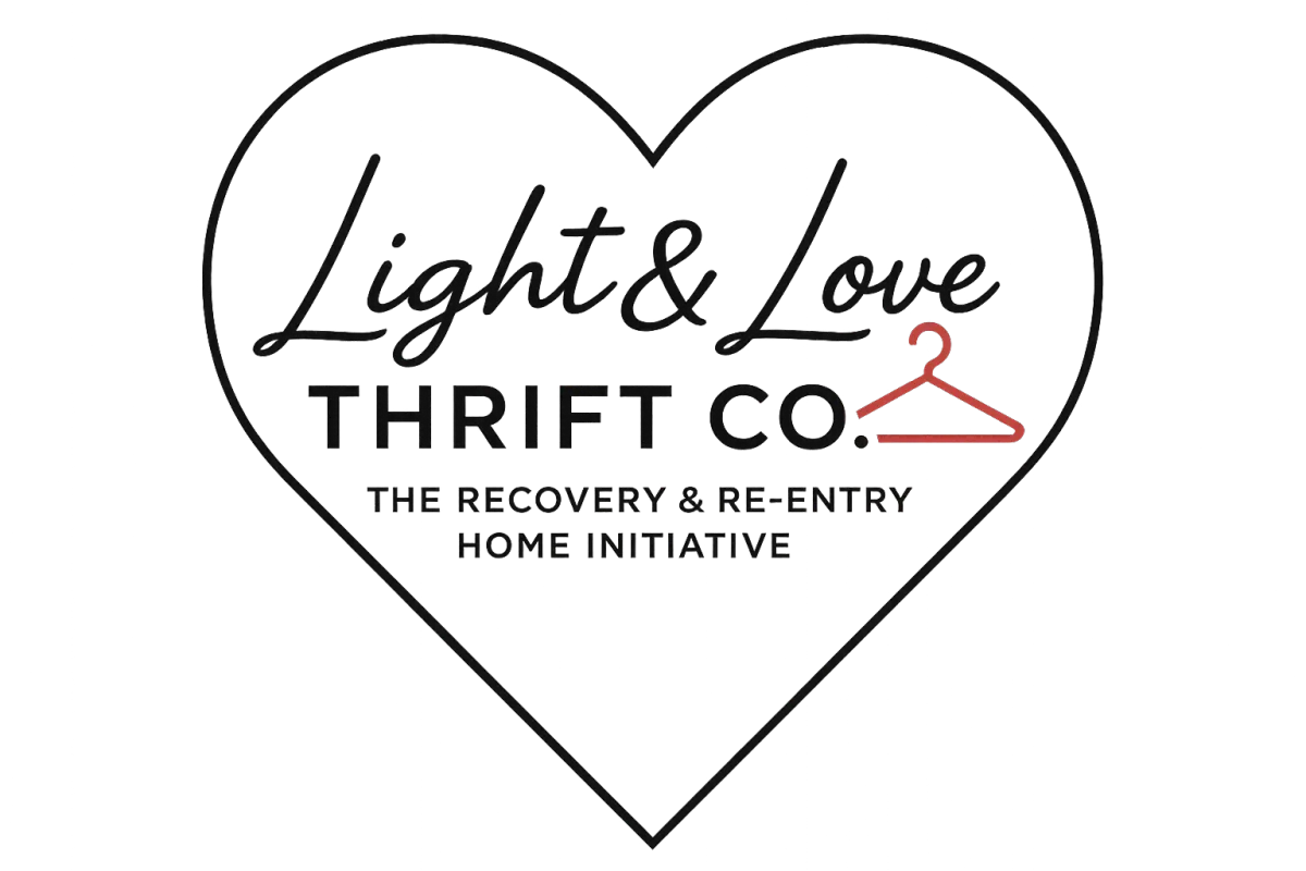 Portrait of Lovan Green, founder of Heart of Change, smiling warmly in a sunlit office, wearing a teal blouse, with expressive eyes and a confident, approachable demeanor. The background features soft focus bookshelves and a potted plant, conveying professionalism and warmth.