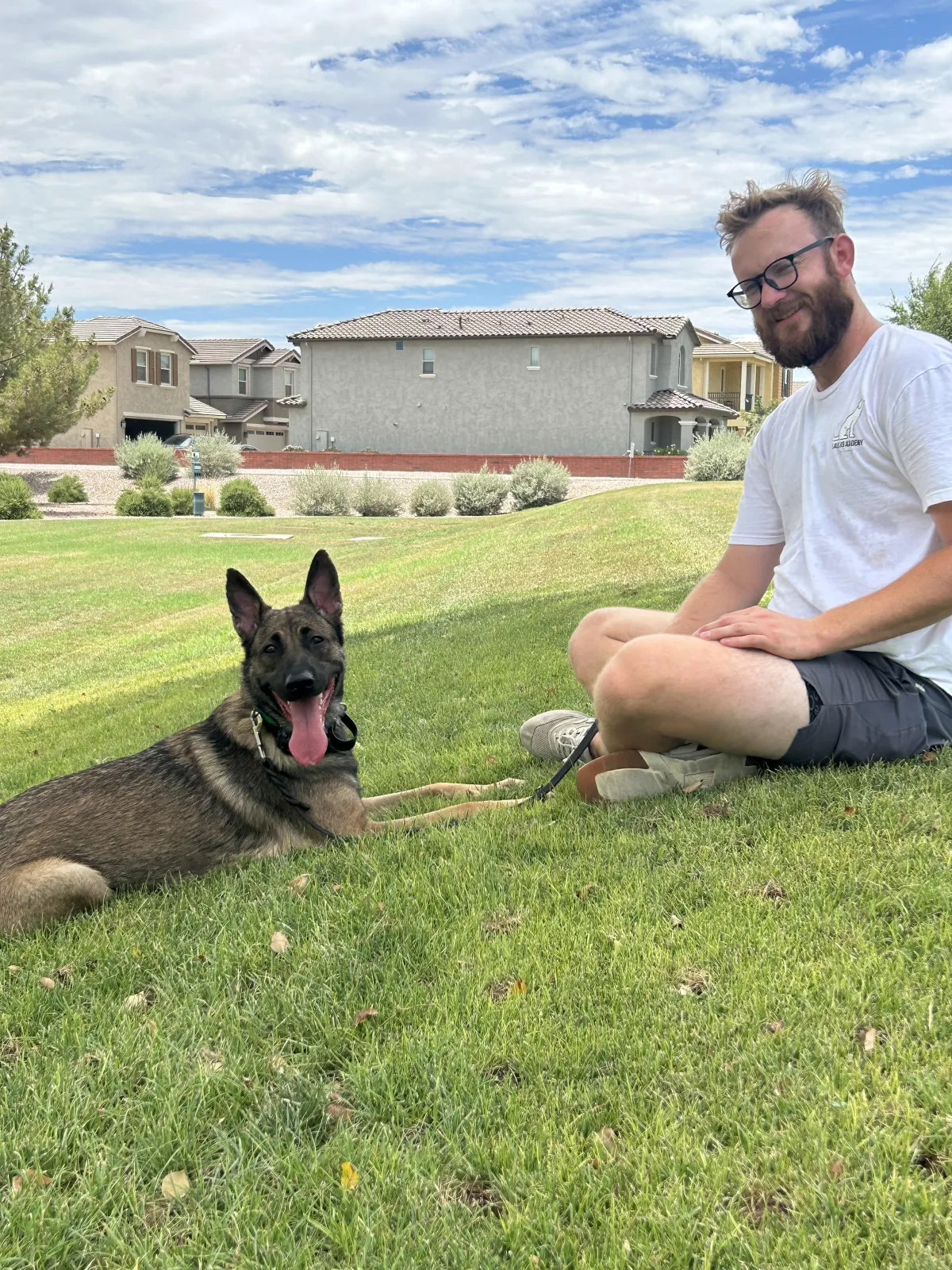 A man walking two dogs on a leash