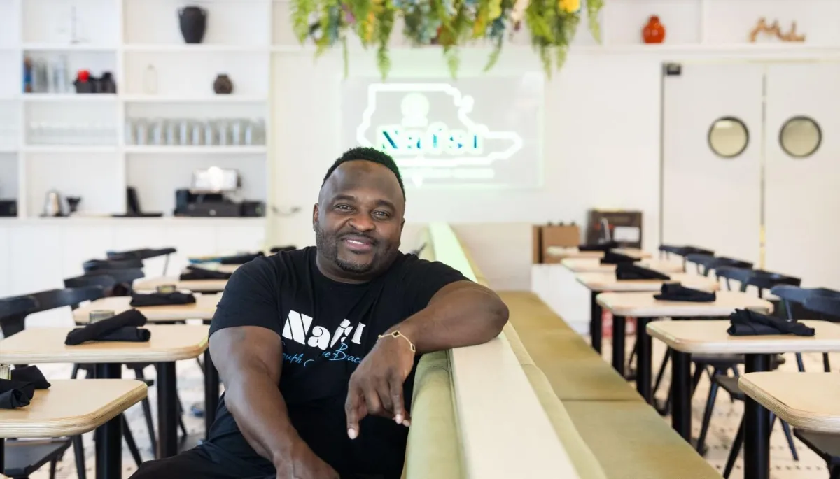 Headshot of Maya R., clinic administrator, neutral background, waist-up portrait