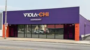 Headshot of Maya R., clinic administrator, neutral background, waist-up portrait