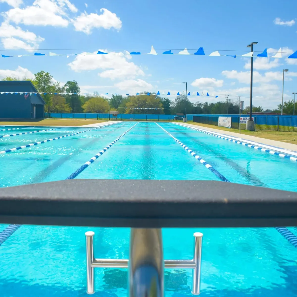 Pool with slides and lounge chairs is shown.