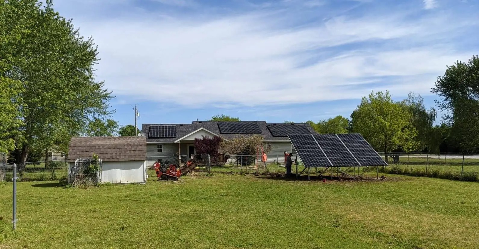 Home with rooftop solar panels at sunset