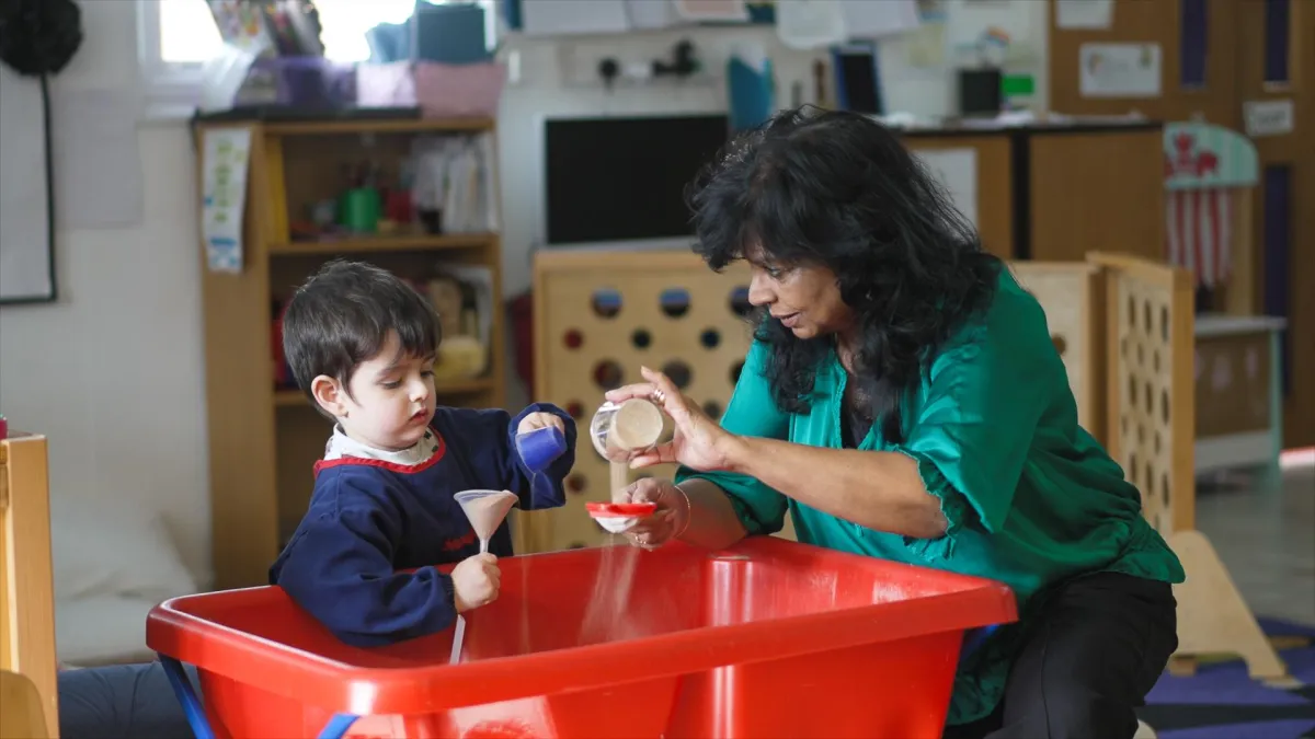 Snowflakes Nursery Owner Engaging In Learning Through Play