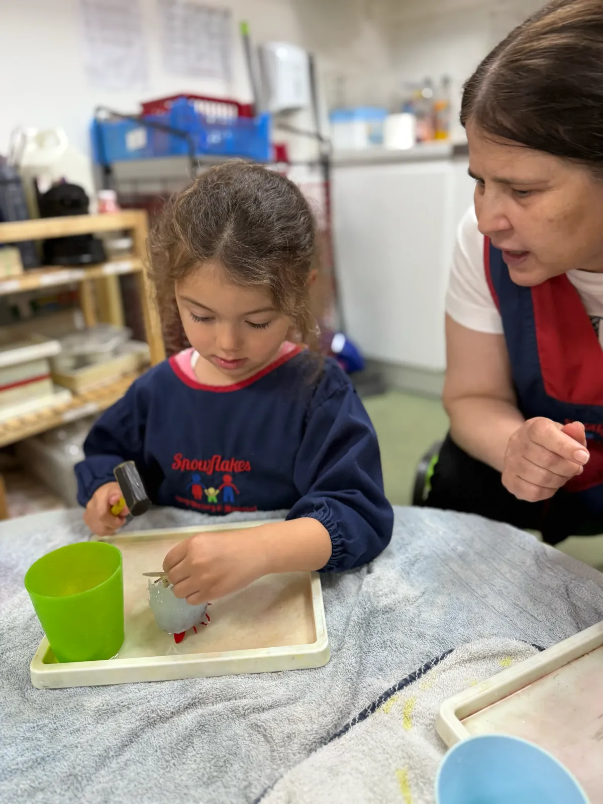 Pre schooler using hammer for creative play