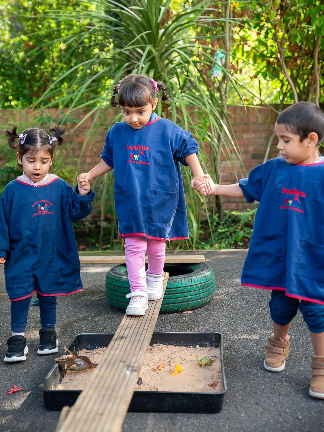 mixed ages children working together to complete obstacle course