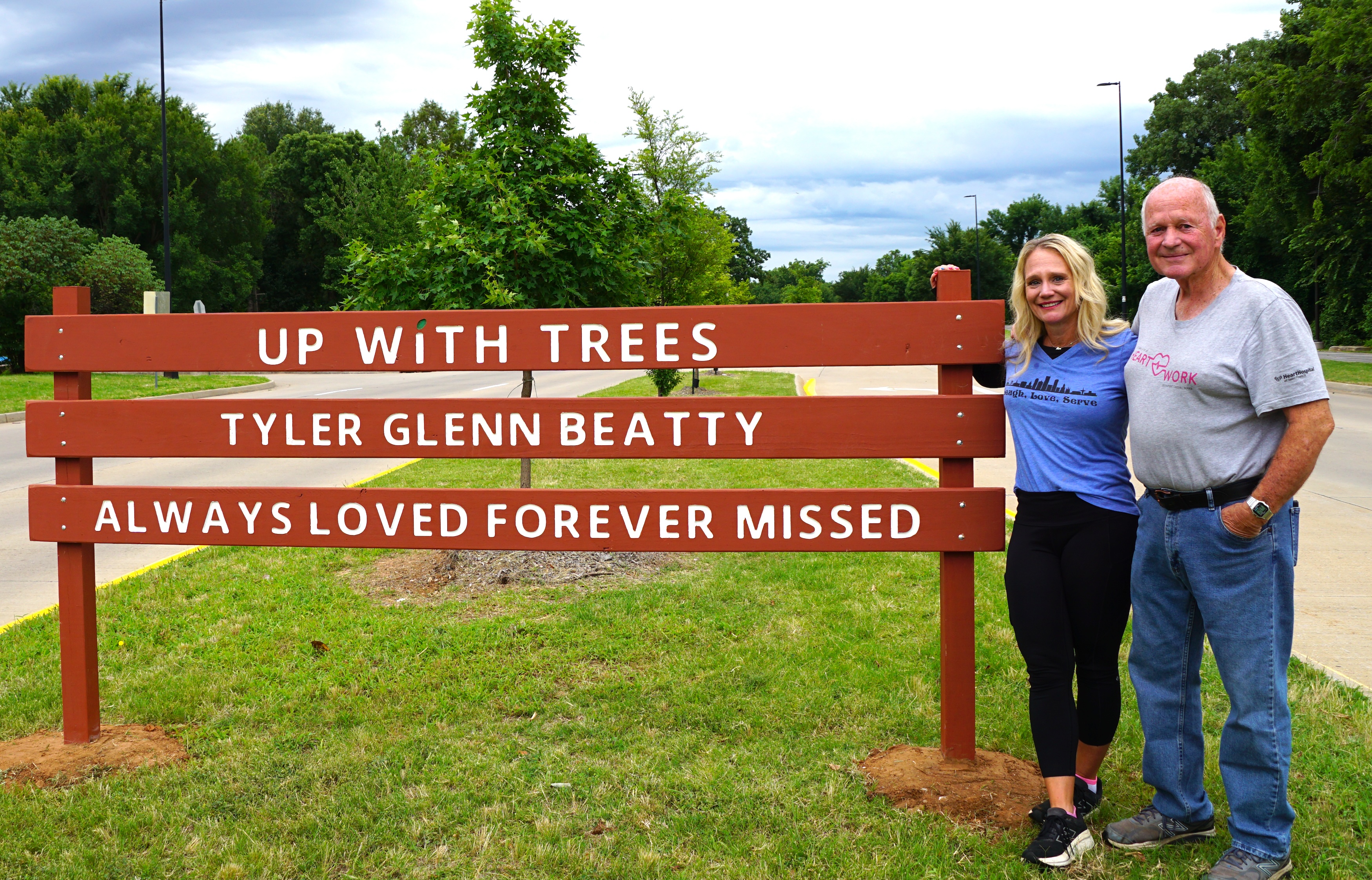 Jennifer Mount and Darrell Glenn Beatty standing beside Up With Trees sign in Midtown Tulsa, Oklahoma