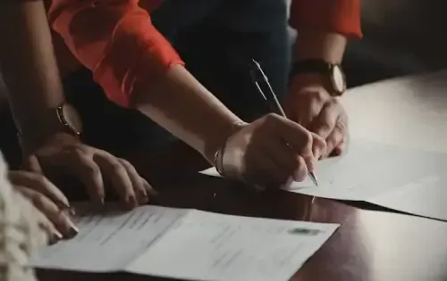 man writing on paper