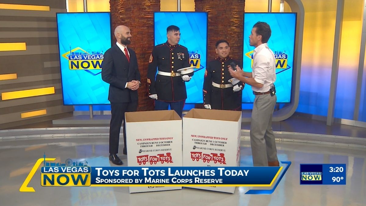 Attorney Ryan Alexander with two Marines and the host on KLAS Channel 8’s Las Vegas Now, standing behind Toys for Tots donation boxes.