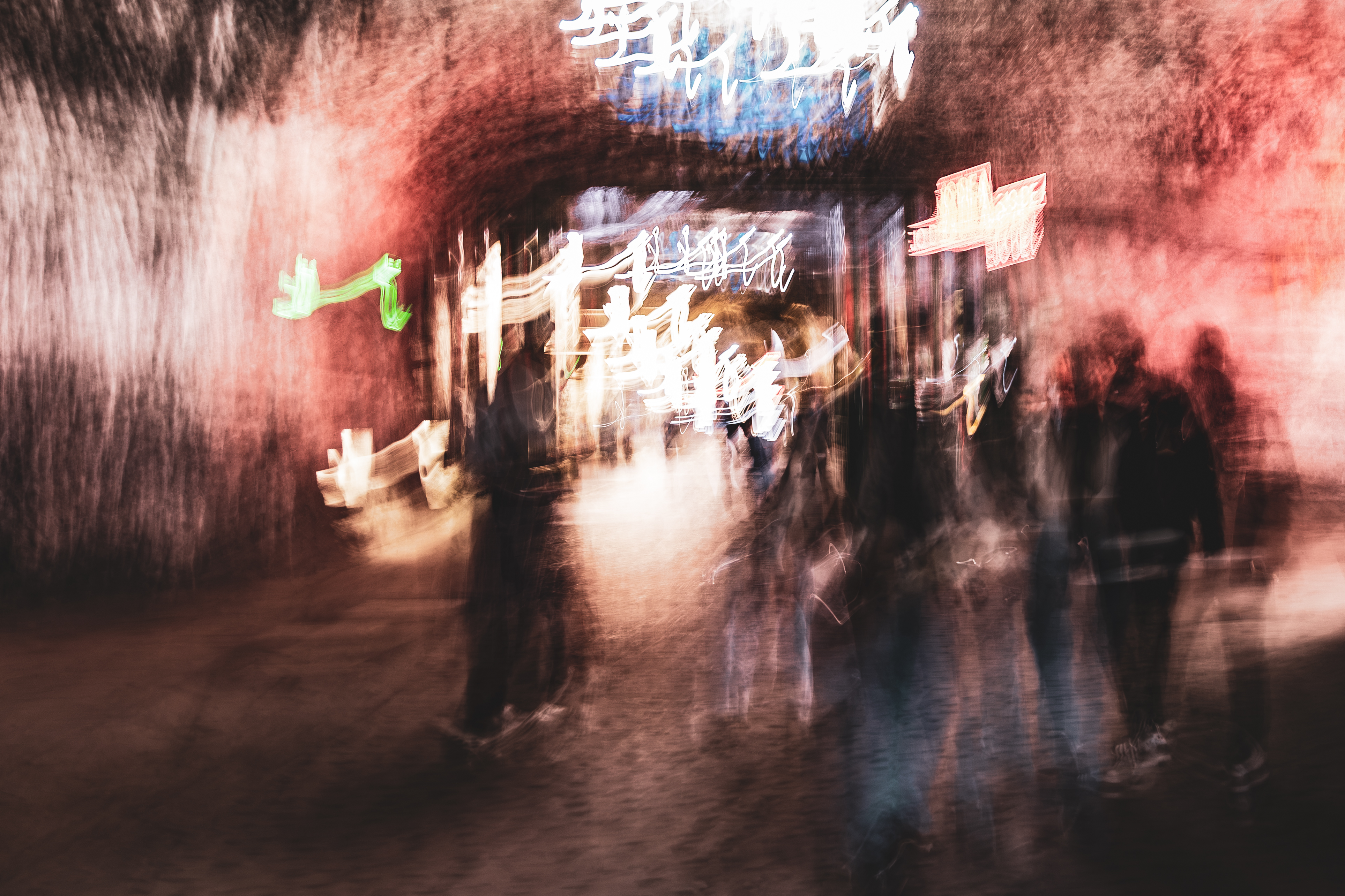 Long exposure ICM photograph of figures gathered in the Salt Cathedral of Zipaquirá, Colombia, colors bleeding through light and shadow like watercolor, by fine art photographer Angie Harker