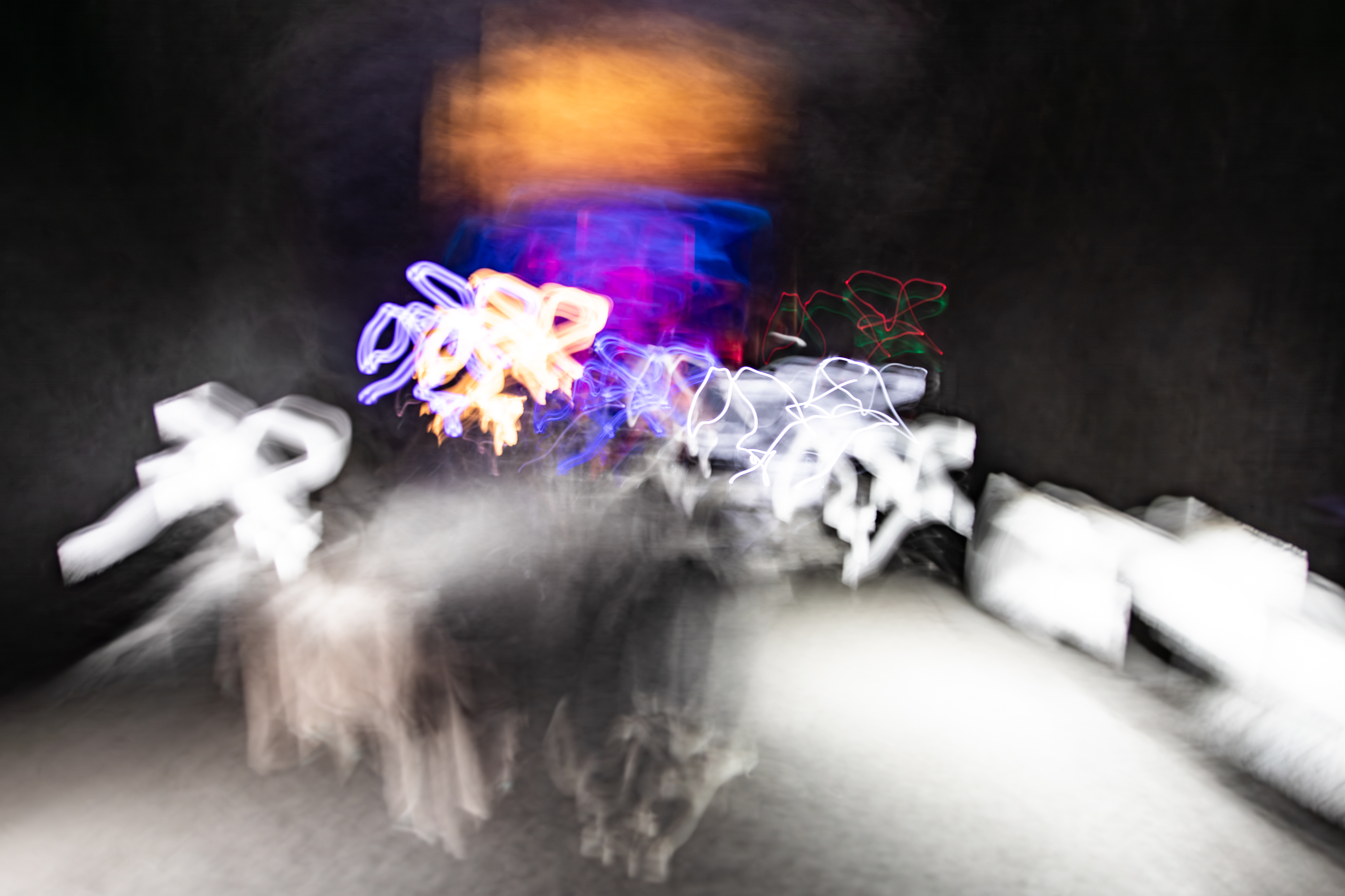Long exposure ICM abstract photograph inside the Salt Cathedral of Zipaquirá, Colombia, ghostly figures emerging through warm light and ancient halite, by fine art photographer Angie Harker