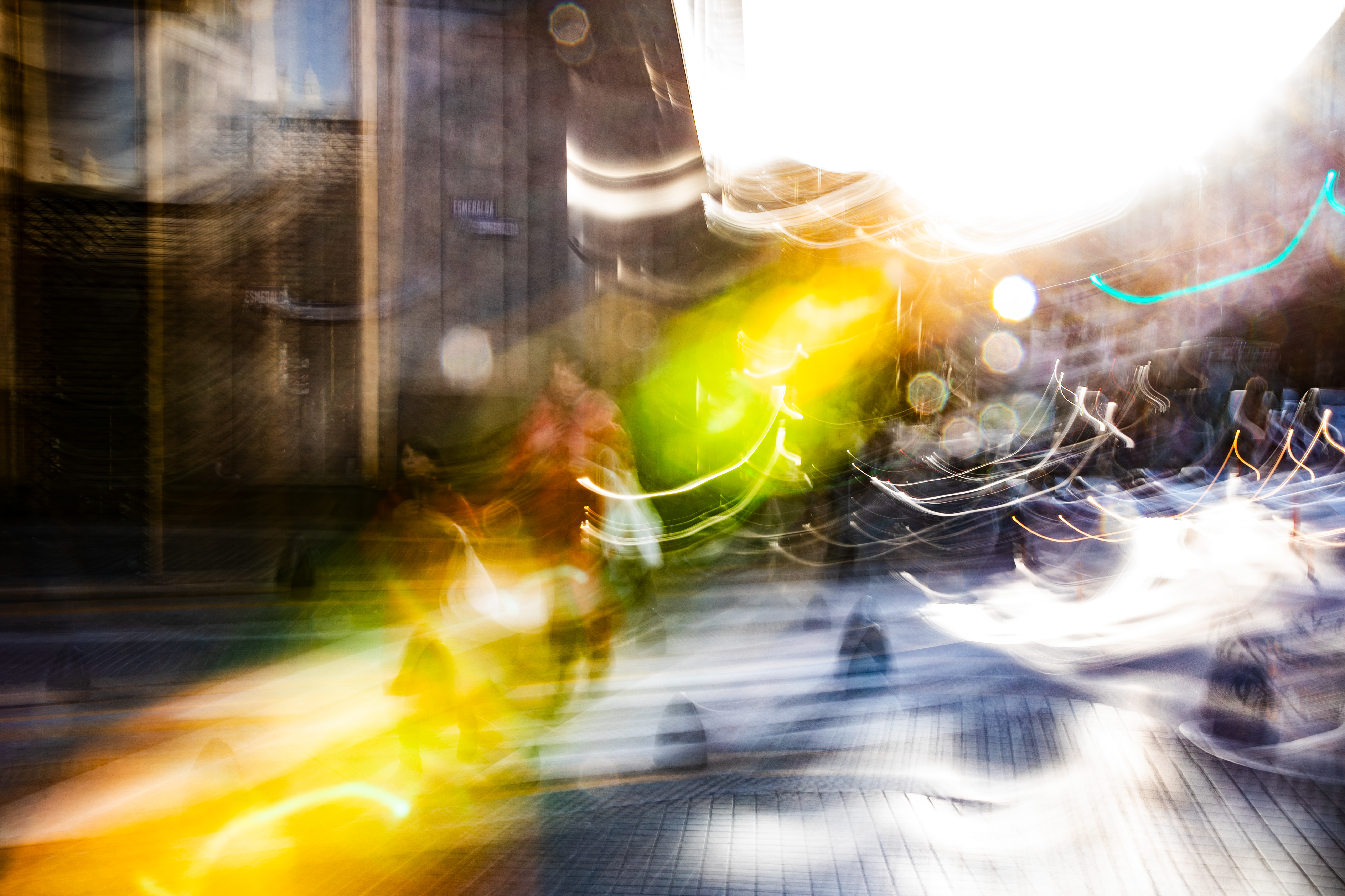 Long exposure ICM photograph of a single figure caught in a spotlight of winter light at a city intersection in Córdoba Argentina, by fine art photographer Angie Harker