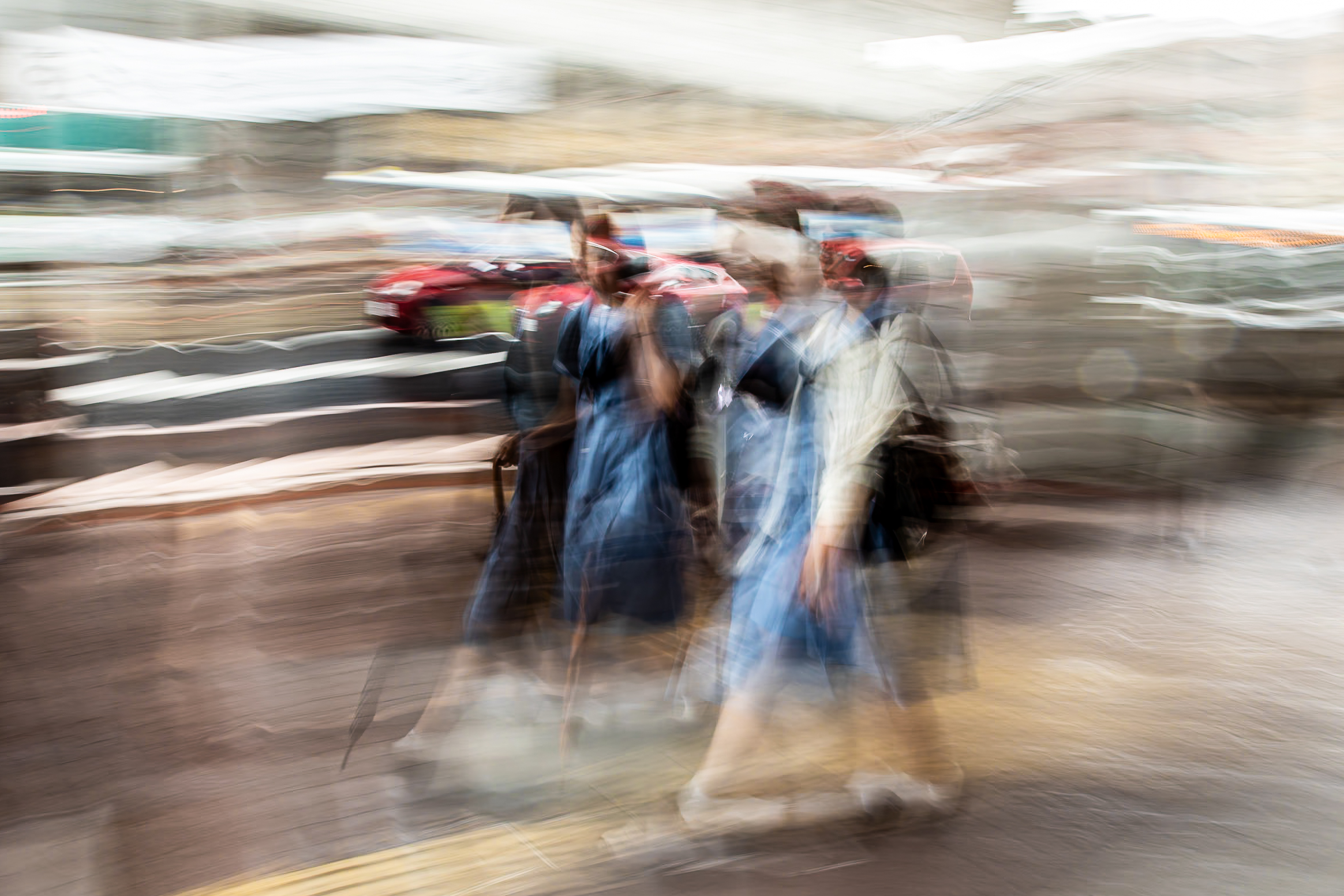 Long exposure ICM photograph of schoolgirls in uniform crossing a Kumamoto street in tropical rain, composed and refined amid the dissolving city, by fine art photographer Angie Harker
