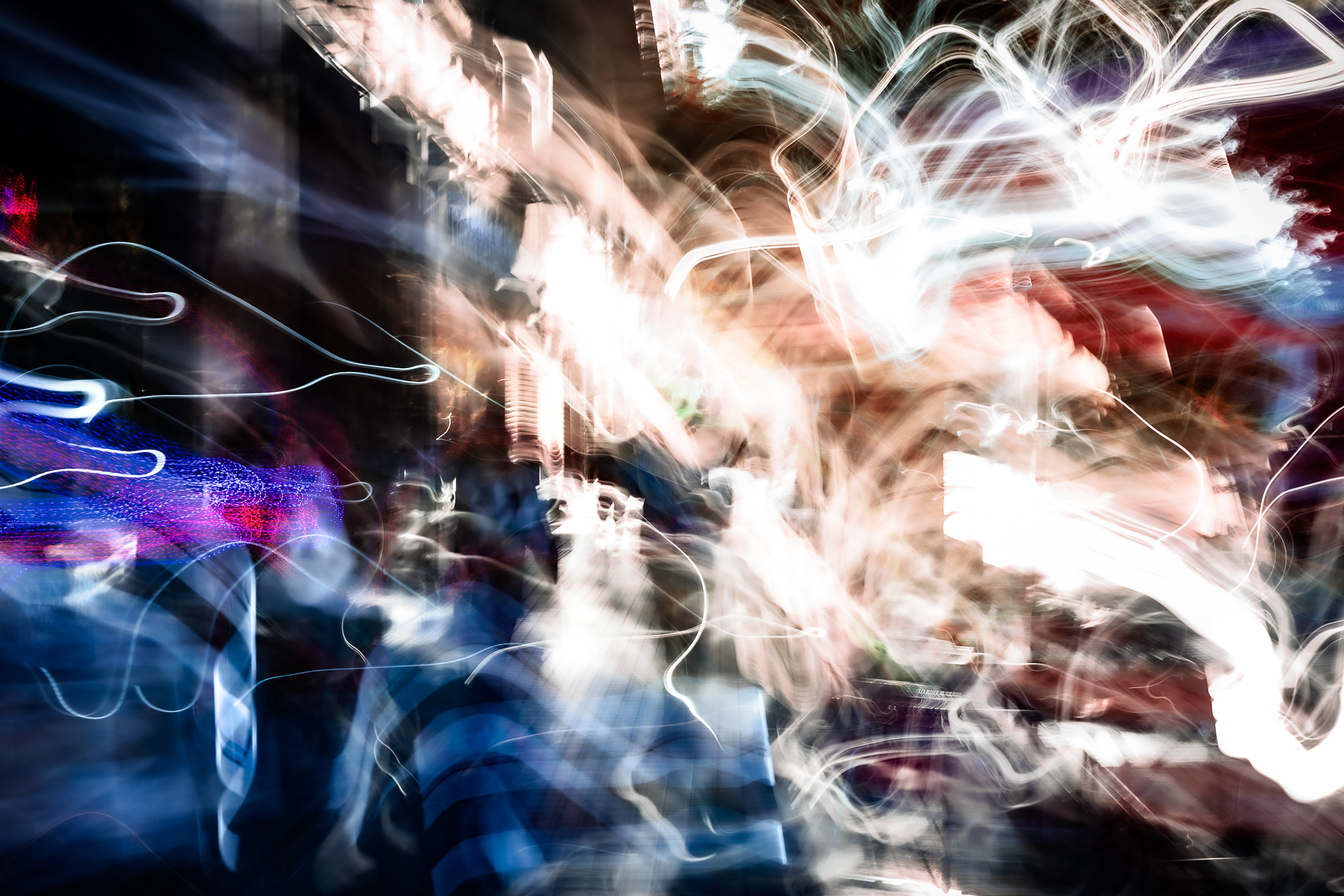 Abstract ICM photograph of Diagonal Norte, Buenos Aires, shooting directly into the sun — the street dissolving into electrical charge, silhouettes suspended within cascading light, by Angie Harker.