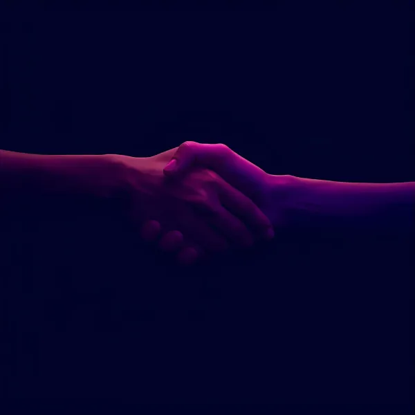 Two hands shaking in a gesture of agreement or partnership, illuminated by dramatic purple and pink lighting against a dark background.