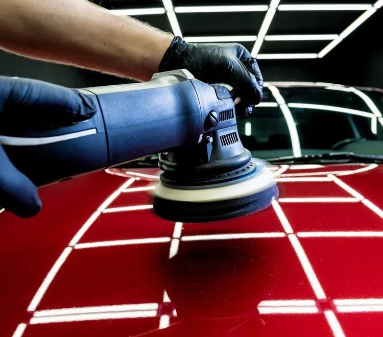 Car paint being polished to remove swirls and scratches