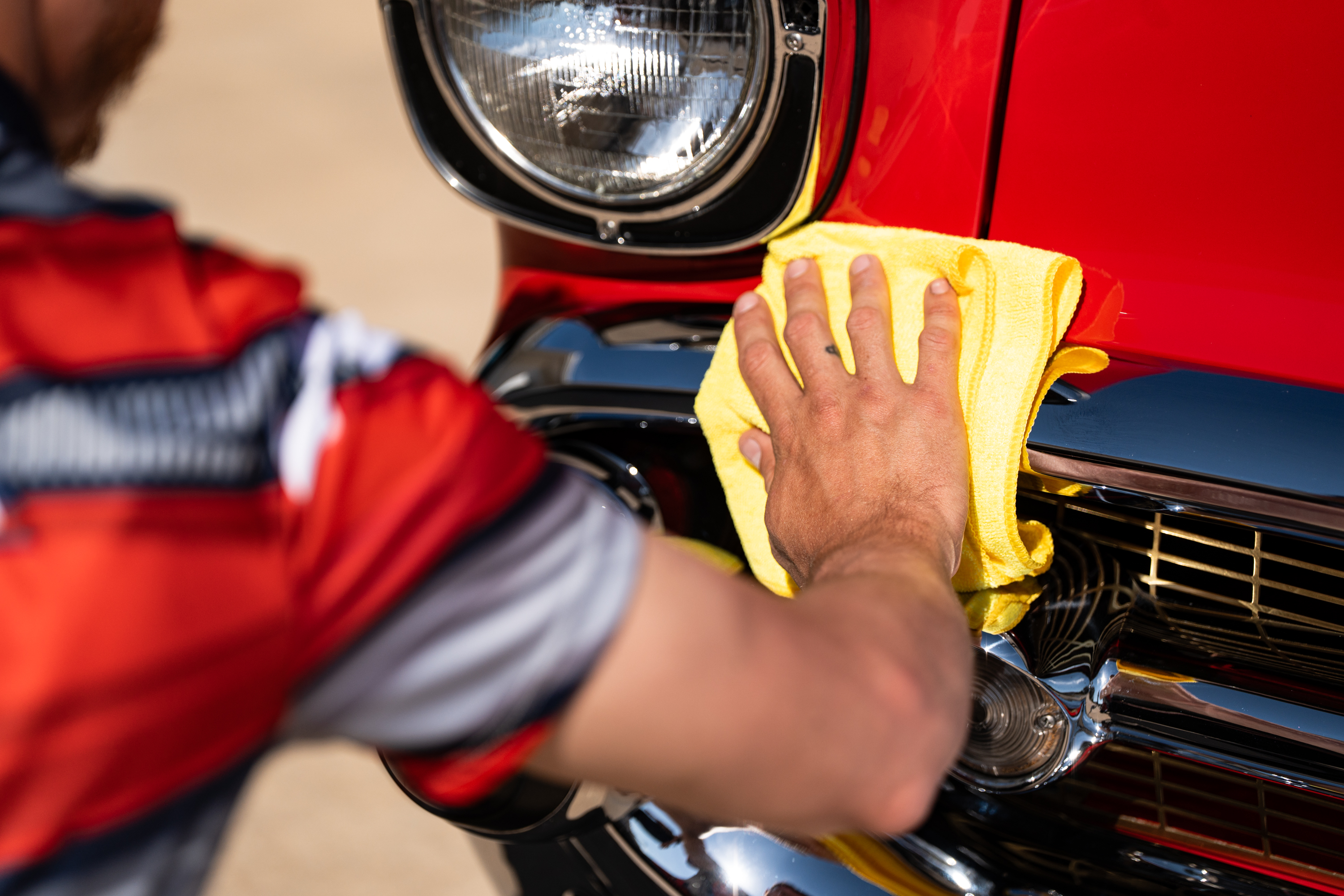 Car detailing technician with phone ready for appointment booking