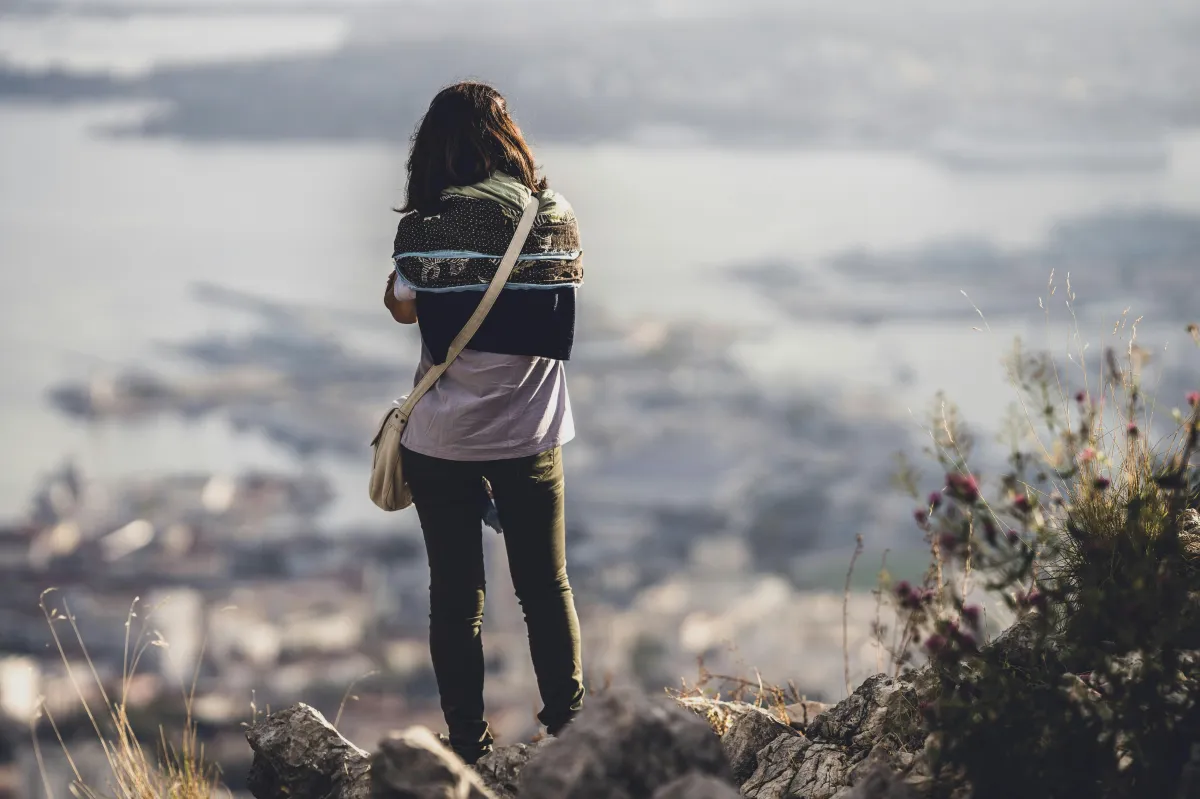 Photo by <a href="https://unsplash.com/@guillaumedegermain?utm_content=creditCopyText&utm_medium=referral&utm_source=unsplash">Guillaume de Germain</a> on <a href="https://unsplash.com/photos/woman-in-brown-jacket-and-black-pants-standing-on-rock-during-daytime-MPD-EarOBro?utm_content=creditCopyText&utm_medium=referral&utm_source=unsplash">Unsplash</a>       