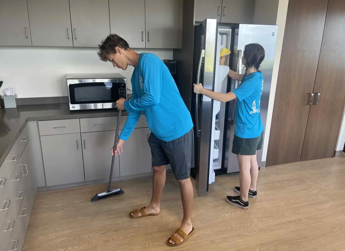 Janitorial team performing commercial cleaning in a building hallway