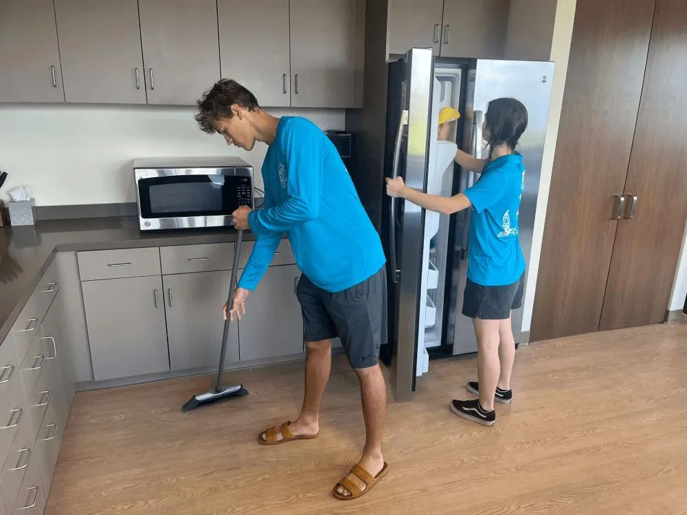 Janitorial team performing commercial cleaning in a building hallway