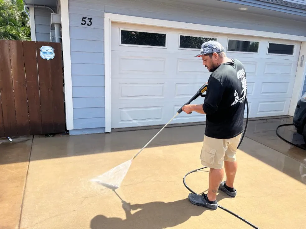 Pressure washing technician cleaning an exterior surface