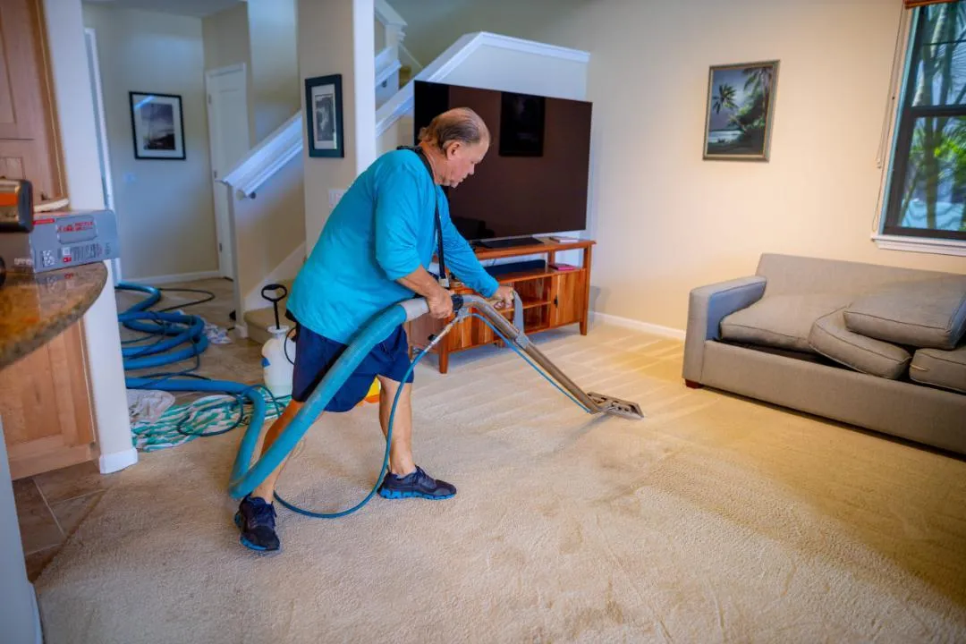 CSI tech doing manual dry prep with a carpet wand