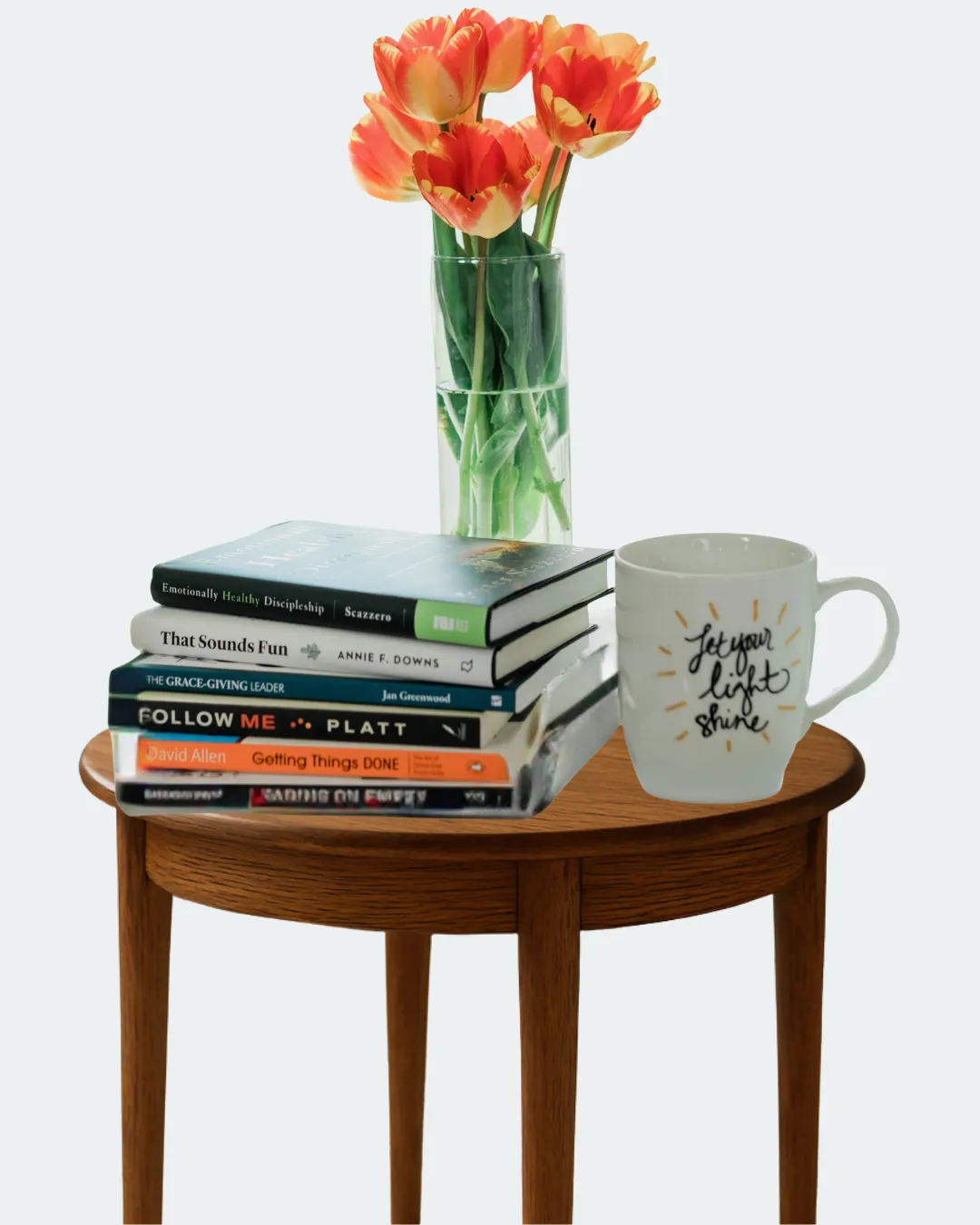table with books and lowers on it.
