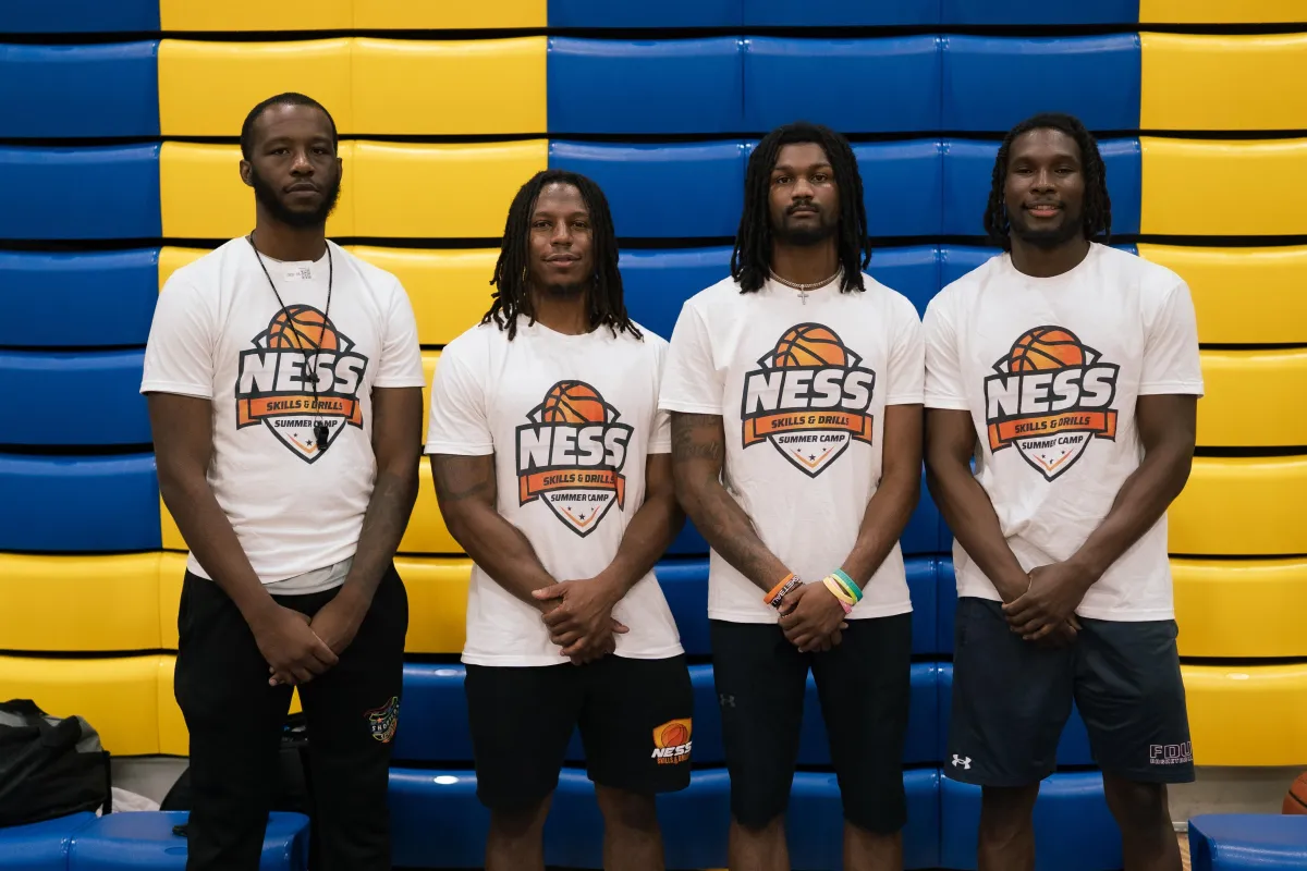 black metal fence near green trees during daytime