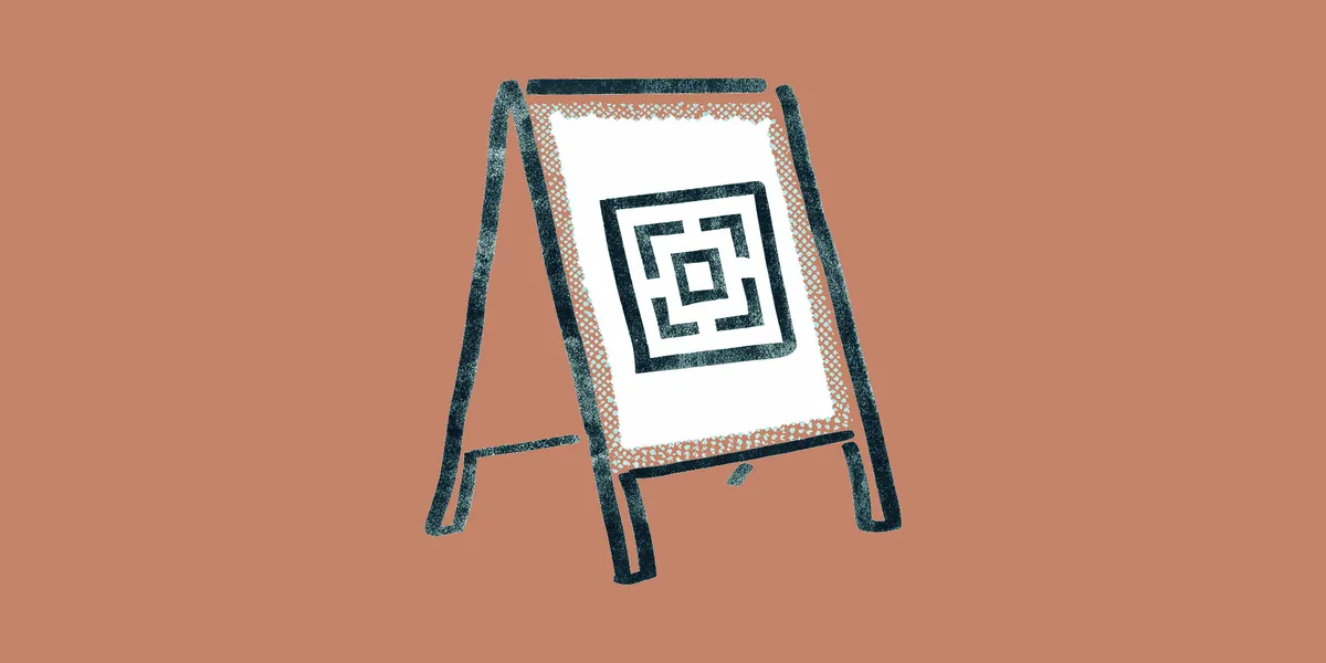 A hand-drawn sidewalk sign with a large QR code on its panel