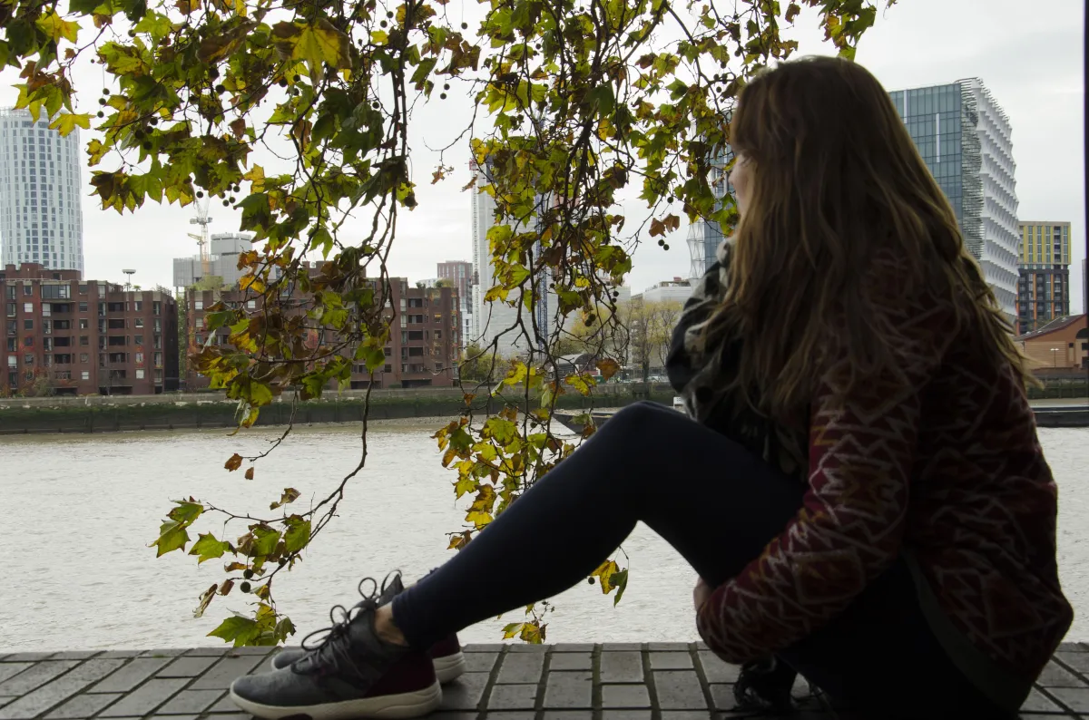 woman sitting and watching the Thames river