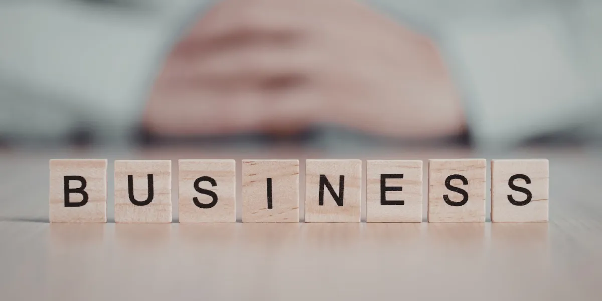 Business strategy concept with wooden blocks and blurred professional background