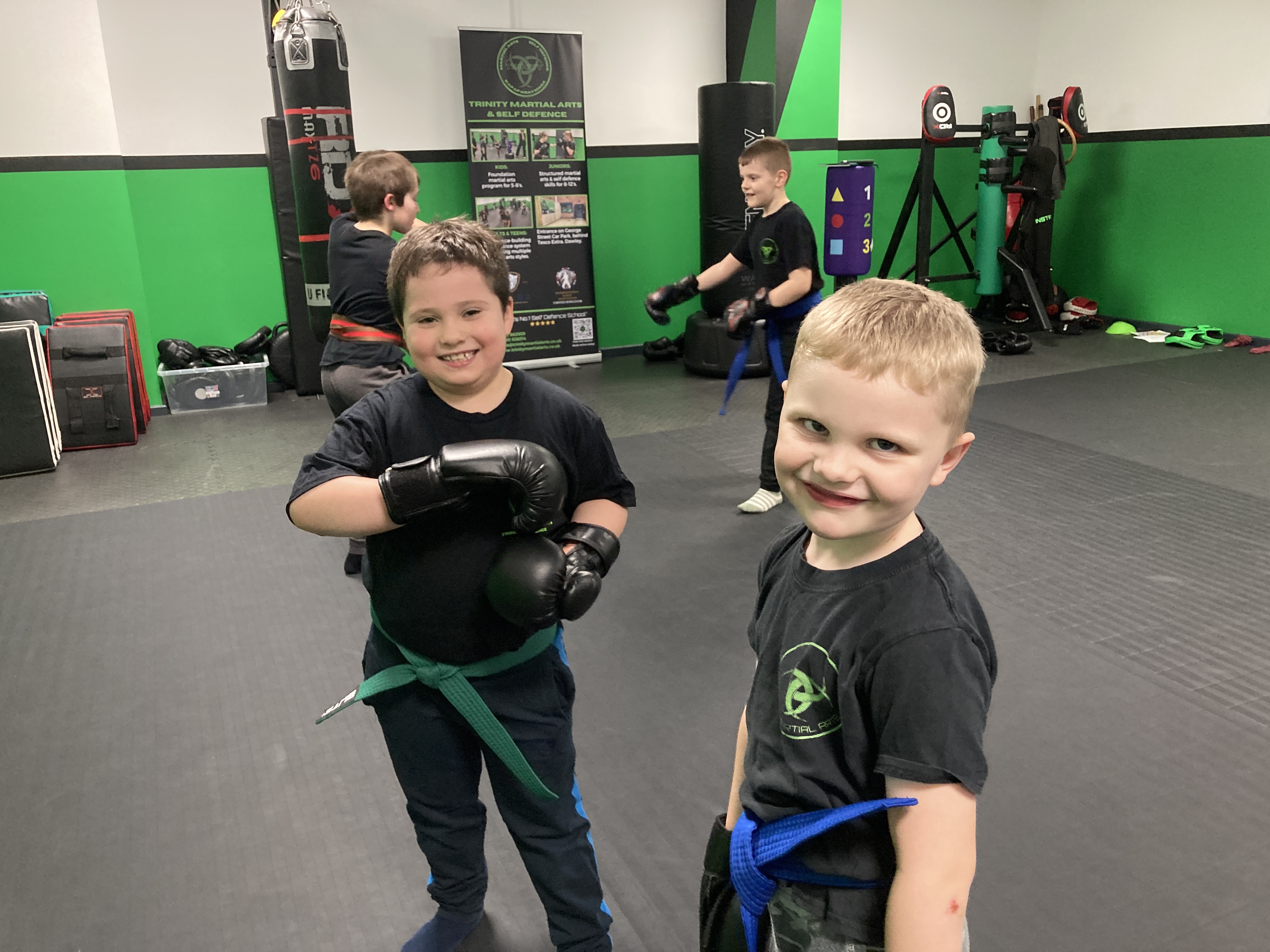Young children aged 5–7 practising martial arts in a structured, fun class