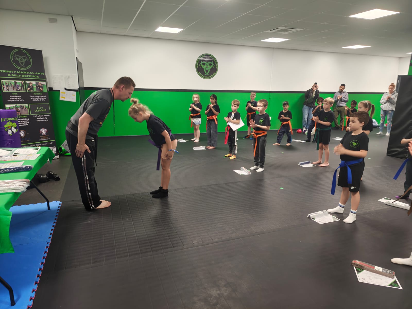 Happy child receiving praise from an instructor.