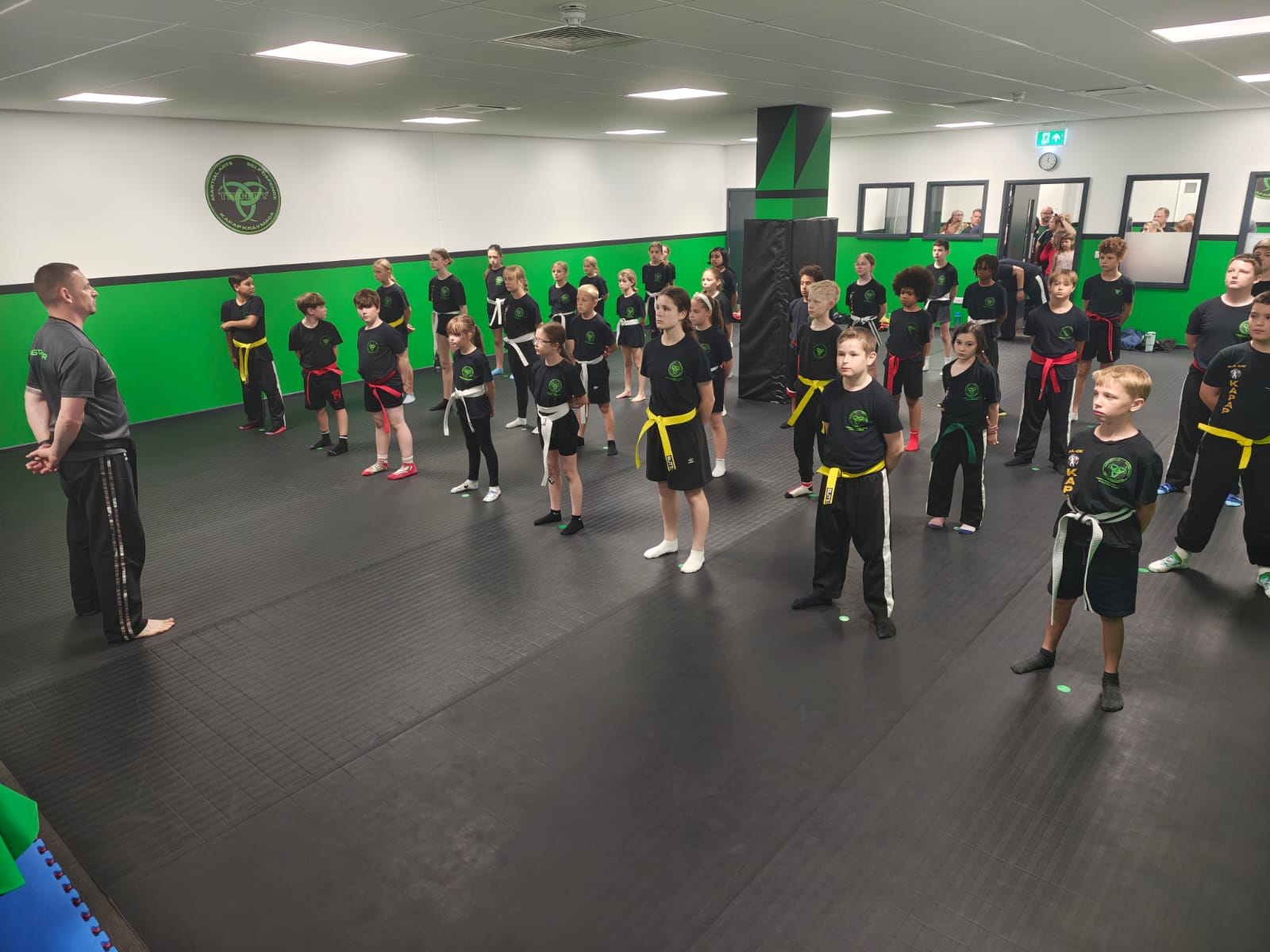 Parents watching a structured kids class.