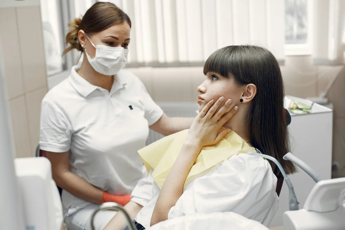 Dentist relieving patient tooth pain