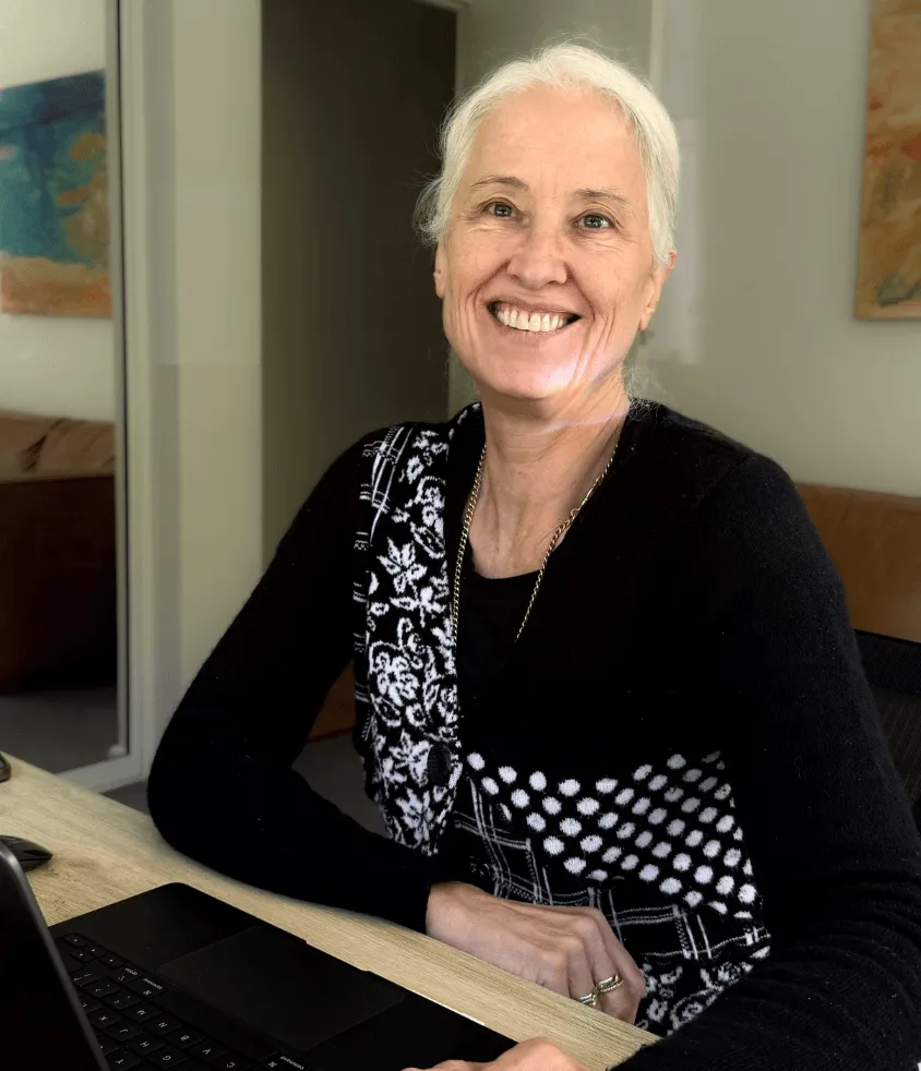 Fair Play facilitator and coach Megan, smiling in Sydney while working online