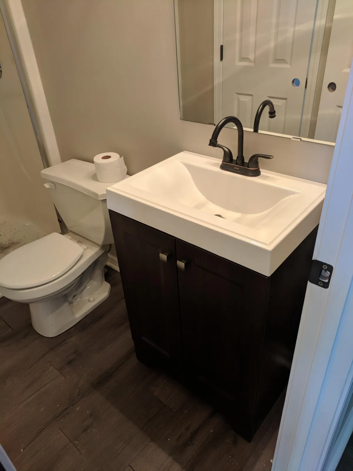 Remodel of bathroom sink and toilet in residential bathroom.