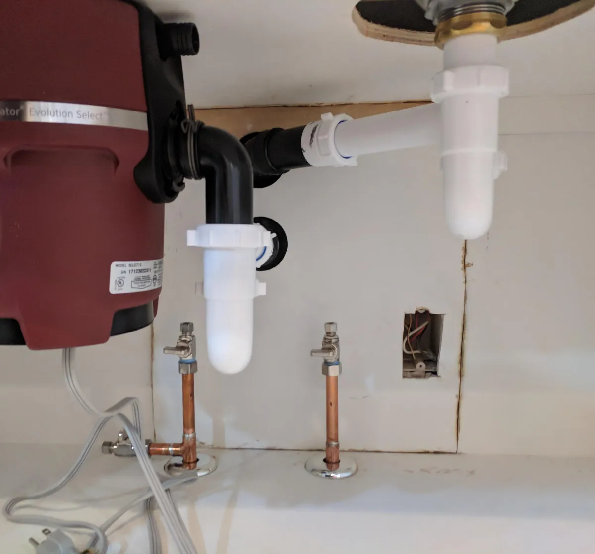 Installation of a new garbage disposal installed by a Fountain City Plumbing technician.