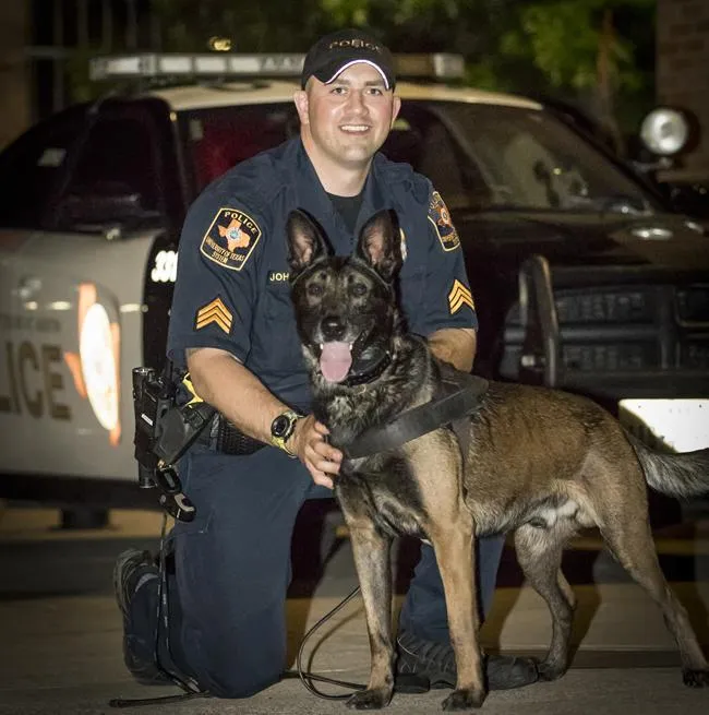 Police officer with a K9 dog trained by Precision K9 Shaping for detection services.