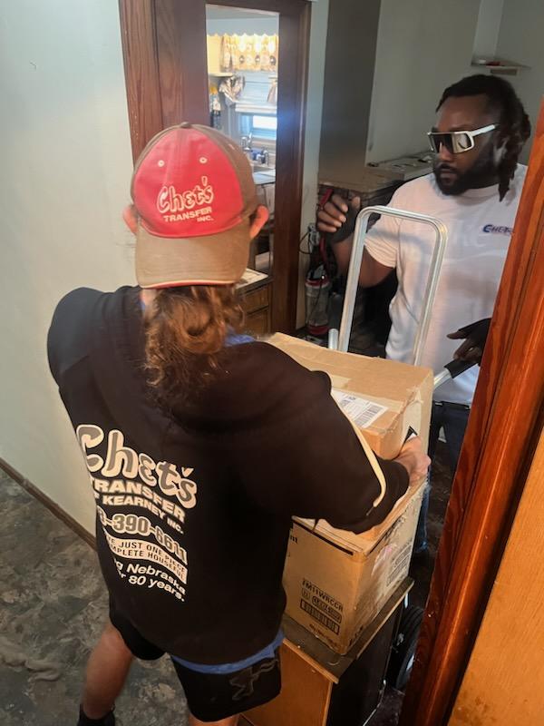 Chet's Transfer of Kearney, Inc. crew member safely transporting packed items for moving