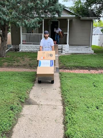 Chet's Transfer of Kearney, Inc. crew members safely loading items into the truck
