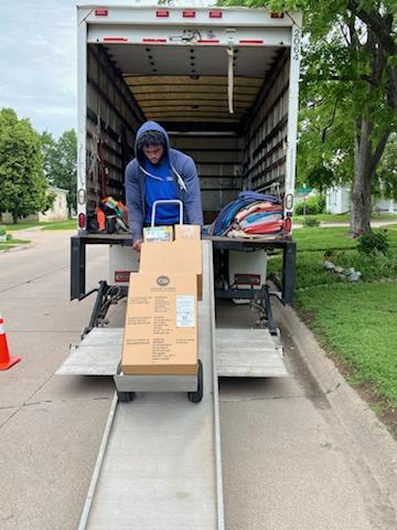Chet's Transfer of Kearney, Inc. crew members safely carrying moved items