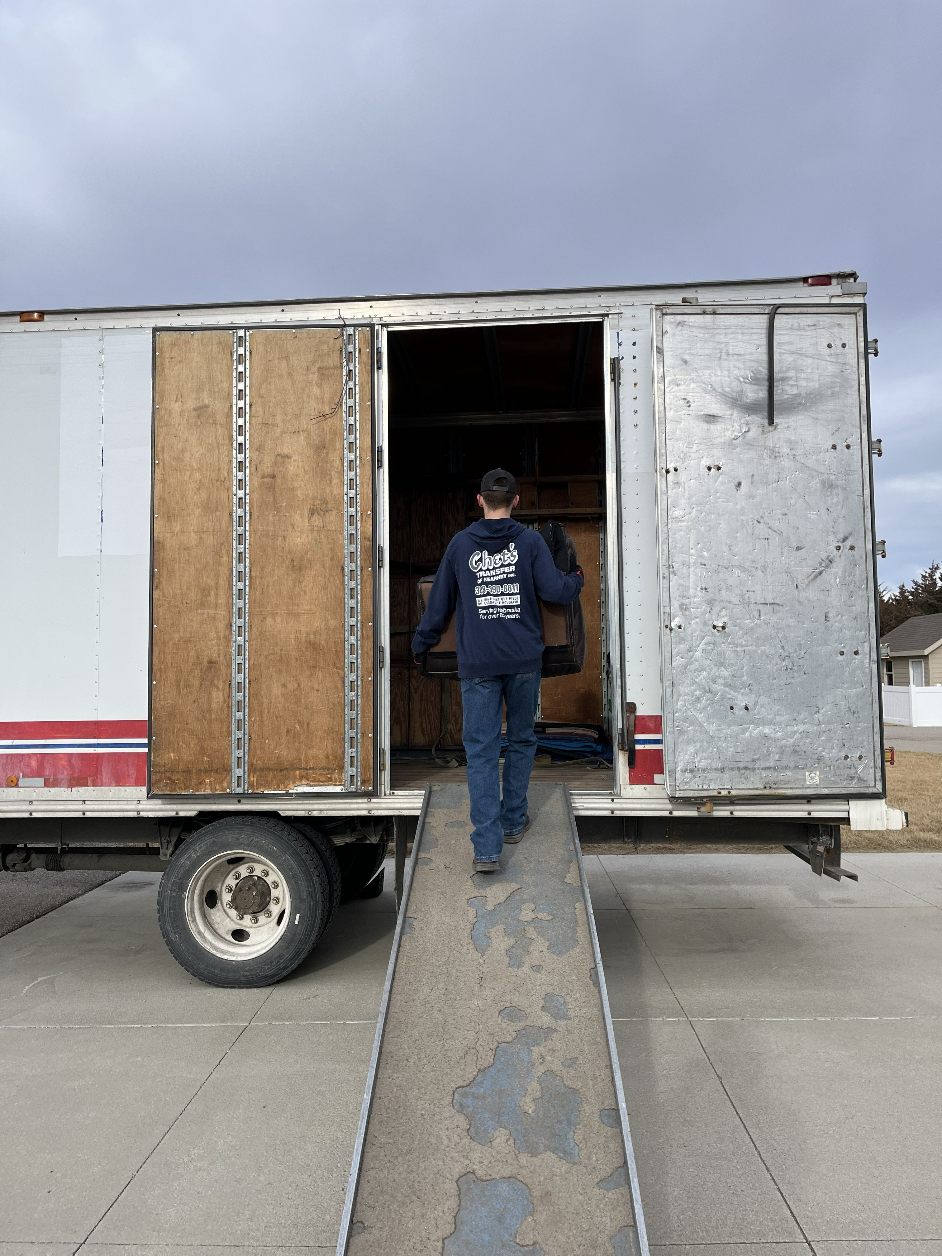 Chet's Transfer of Kearney, Inc. crew members safely loading items into the truck
