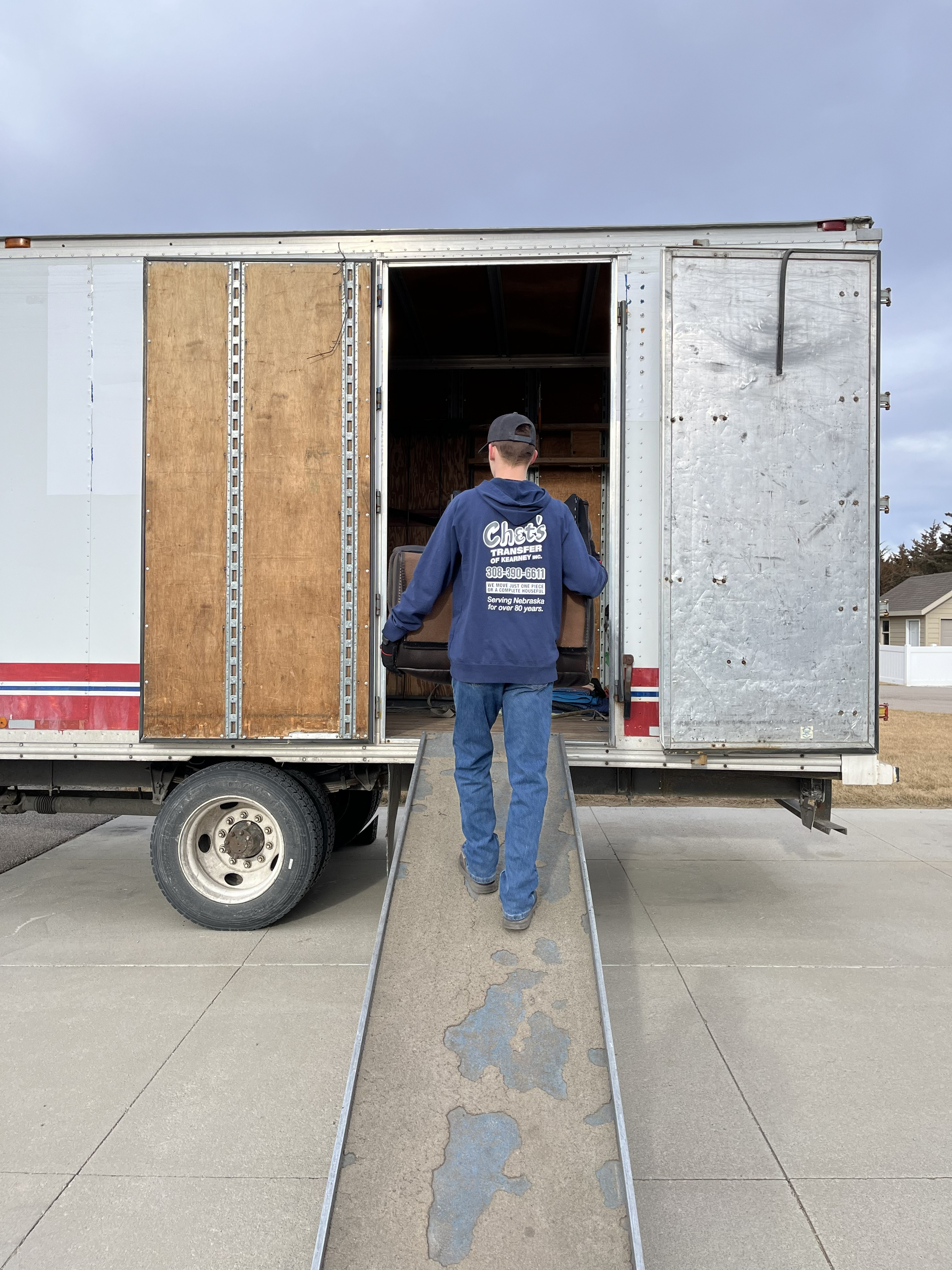 one of Chet's Transfer of Kearney, Inc.'s crew member carefully loading items into the truck
