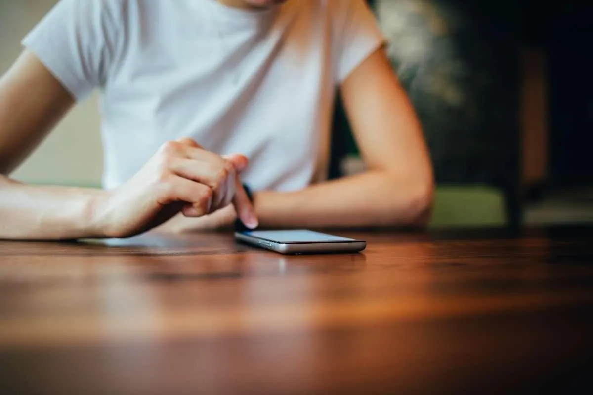photo of a woman downloading a Savannah real estate market report