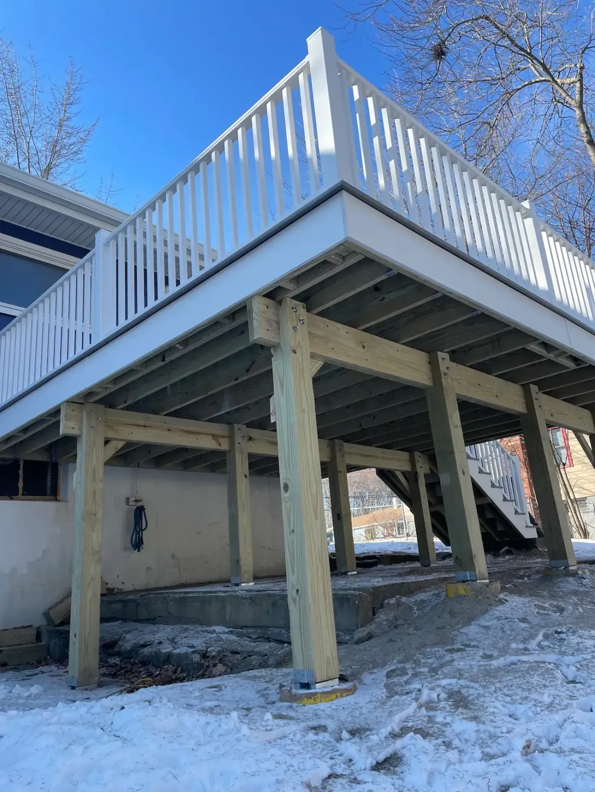 Patio-to-deck conversion transforming an existing backyard patio into a custom deck in Beverly, MA.