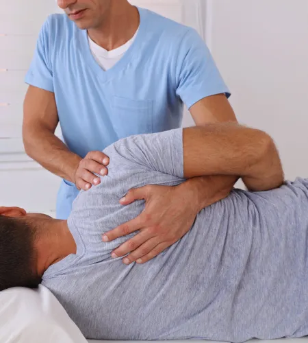 Chiropractor fixing a patient's joint pain