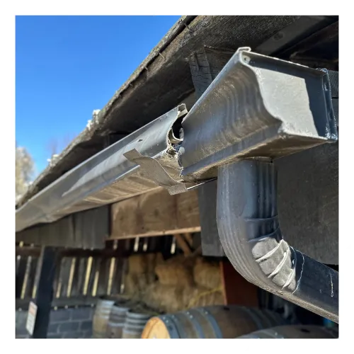 Gutter repair team fixing damaged gutters on a home in Murfreesboro, TN