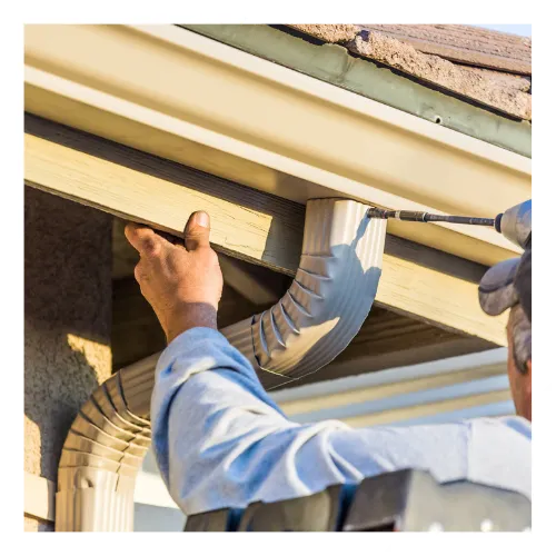 Technician fixing a leaking gutter on a home in Franklin, TN