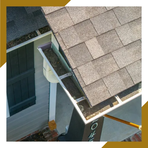 Crew performing roof and gutter cleaning for safer water flow